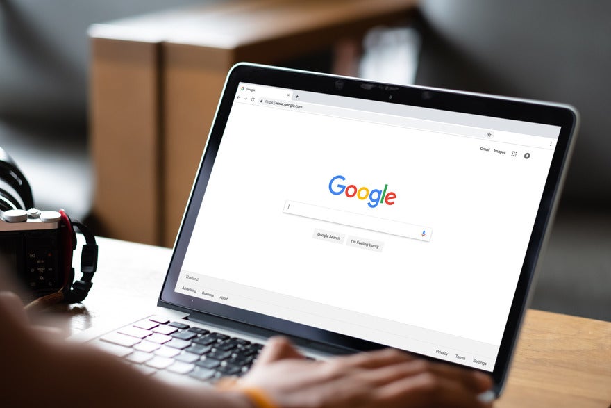 AdobeStock_294425685_Editorial_Use_Only (1) Person working on a laptop with the Google homepage displayed on screen