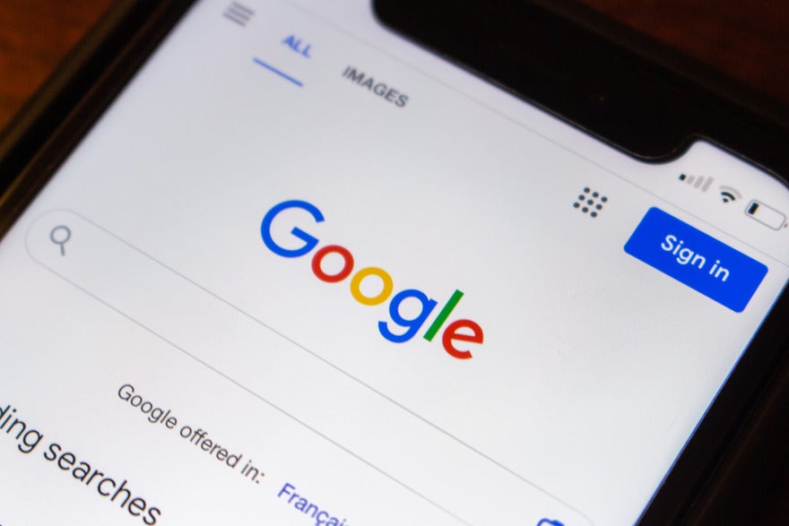 AdobeStock_546419241_Editorial_Use_Only (1) Mobile device showing Google search homepage