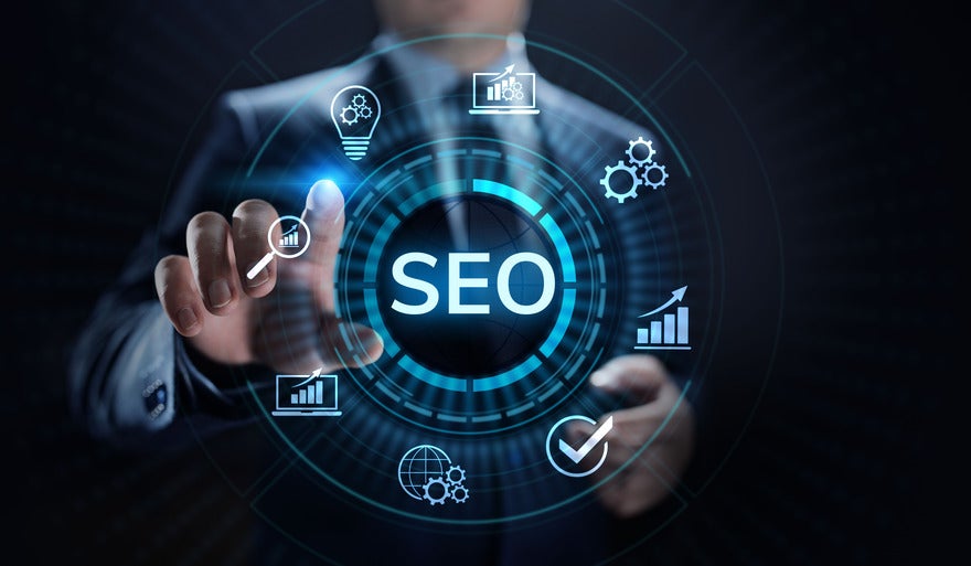 Debunking SEO myths Man pointing at various SEO symbols floating in the air