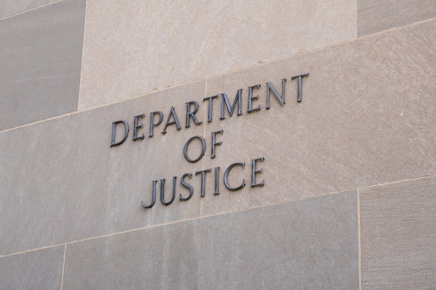 DOJ proposes Google breakup Wall with "Department of Justice" displayed on the side