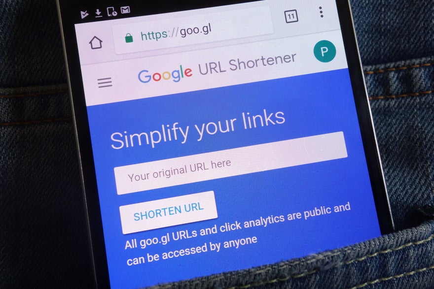 End of Googl shortened URL Phone in pocket showing the Google URL Shortener tool homepage