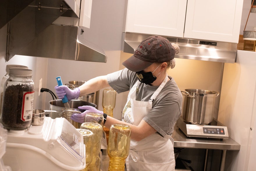 Erin's Elderberries 1 Woman mixing syrup in a kitchen