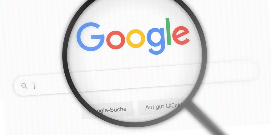 June SERP volatility Magnifying glass hovering over the Google homepage